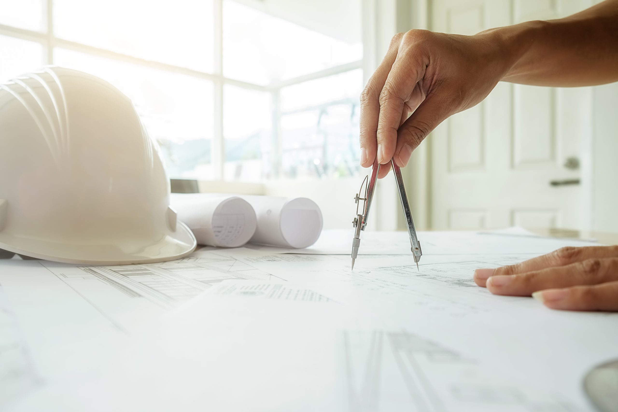 Hands of Engineer working on blueprint,Construction concept. Eng